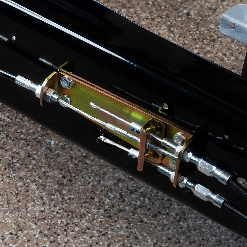 E-Stopp brake cable junction bracket installed on a black frame rail