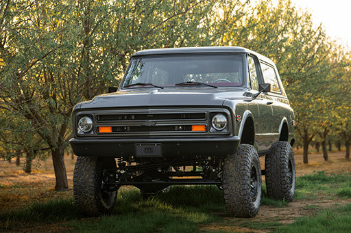 PPC Blazer parked in a field with trees in the background